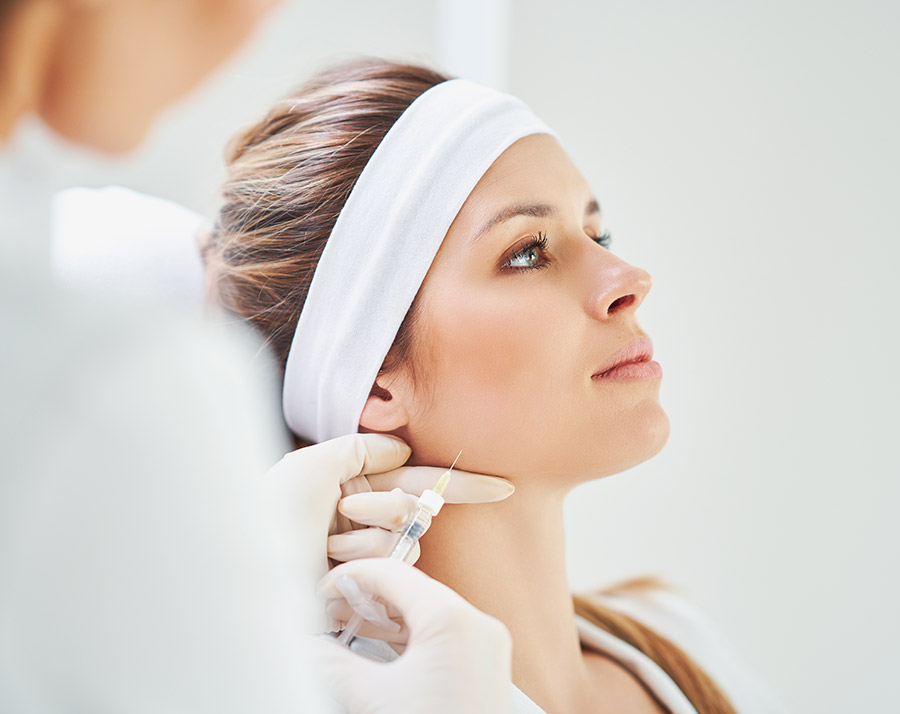 Professional Botox injection treatment near the jawline at a medical spa.